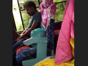 A guy pleasures himself on a bus under the scrutiny of some girls who are recording him