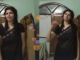 Indian auntie flaunts her curves in black transparent saree