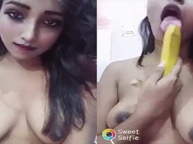 A shy single girl pleases herself with a banana in a nude video