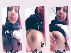 Young hijabi woman reveals her ample bosom on camera