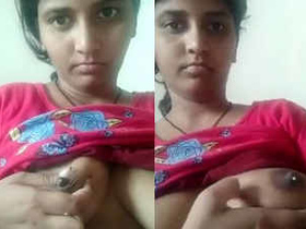 A South Asian woman squeezes her nipple