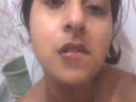 A lovely Indian girl with large breasts pleasures herself