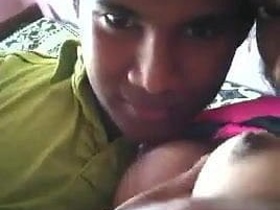 A young woman from Sri Lanka with firm breasts kisses while fondling her nipples
