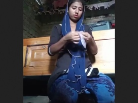 A young woman from Bangladesh masturbates inside a condom with her fingers