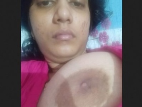 A sultry Desi woman entices with her ample breasts and intimate area