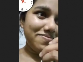 This video features a beautiful woman proudly displaying her large breasts