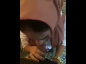 A seductive woman wearing a hijab pleases her partner with an erotic oral experience