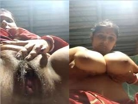 Busty Indian babe Budi flaunts her big boobs and moist pussy