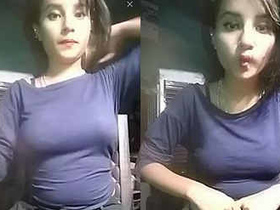 A stunning Indian girl flaunts her curves in a form-fitting dress and poses seductively in a call