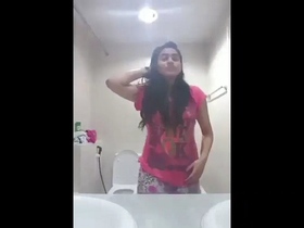 A young Indian woman showcases her curves and self-pleasure in a solo video captured on her mobile device