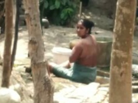 Hidden camera captures Indian aunt's nude bath in backyard