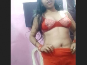 Hema wearing a bra displays her large breasts