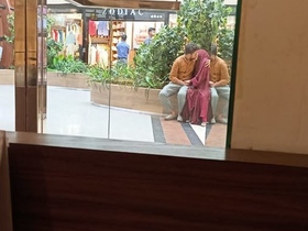 Passionate smooching in a daring public setting