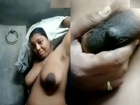 Mature Indian woman flaunts her large breasts in a revealing outfit