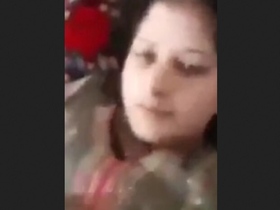 A Pakistani woman with large breasts proudly displays them