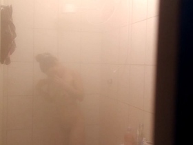 Filming my attractive relative as she enjoys a steamy shower