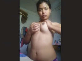 A stunning woman flaunts her ample bosom in a captivating performance.