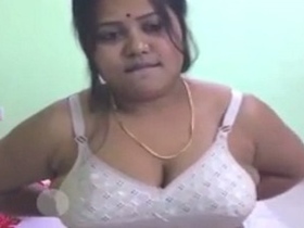 Watch a curvy Indian babe strip down and show off her big boobs