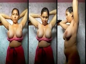 Desi girl with massive natural breasts undressing in the bathroom