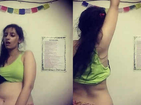 A seductive Indian beauty performs a sensual dance, showcasing her toned stomach