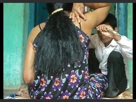 A barber removes hair from a girl's underarm