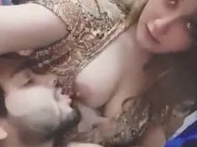 A stunning girl's breast is orally pleasured by her male partner