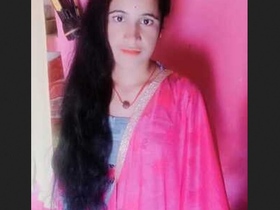 A beautiful Indian woman in traditional clothing gets ready after taking a bath