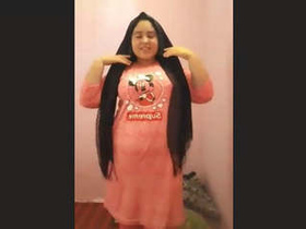 Young woman displays her large breasts sensually