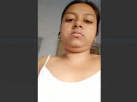 A video of a South Asian woman with large breasts for her admirer, including urination