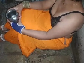 Indian sister showcases her natural beauty while washing in a rural setting