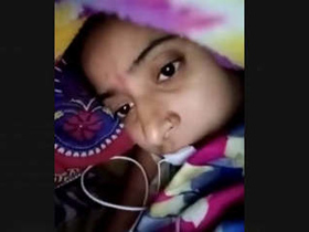 A charming Indian woman fondles her breasts and vagina during a video call