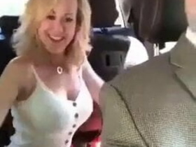 A sexy MILF changes her outfit in a car