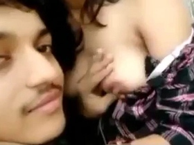 Watch a loving couple smooch and suck boobs in this steamy video