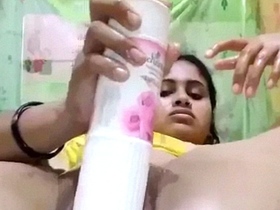 Watch a stunning Indian girl use a bottle of air freshener for masturbation