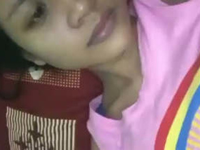 A pretty and youthful girl displaying her breasts