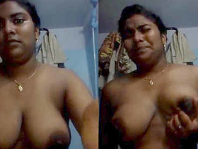 Indian teenager squeezes her breasts with a passionate look
