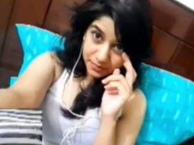 A beautiful girl indulges in breast play during a video call with her boyfriend